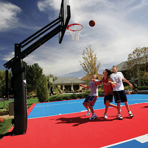 Kids playing basketball on SYNCourt outdoors
