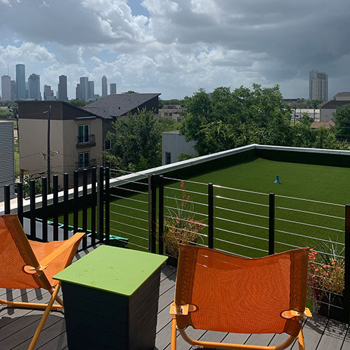 synlawn artificial turf with orange chairs and a view
