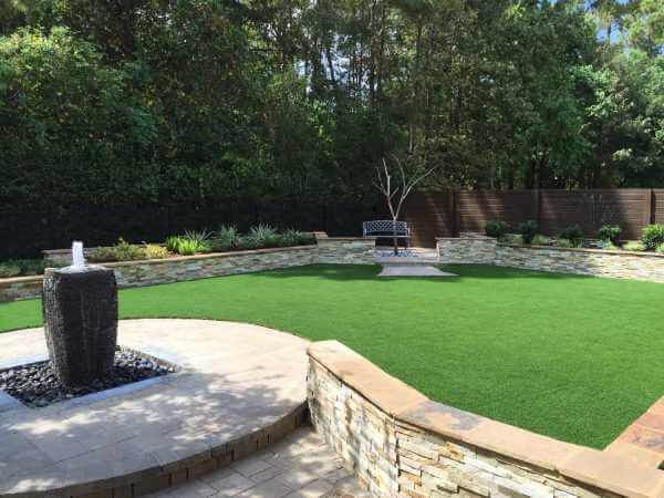 Bench and fountain in an artificial grass area