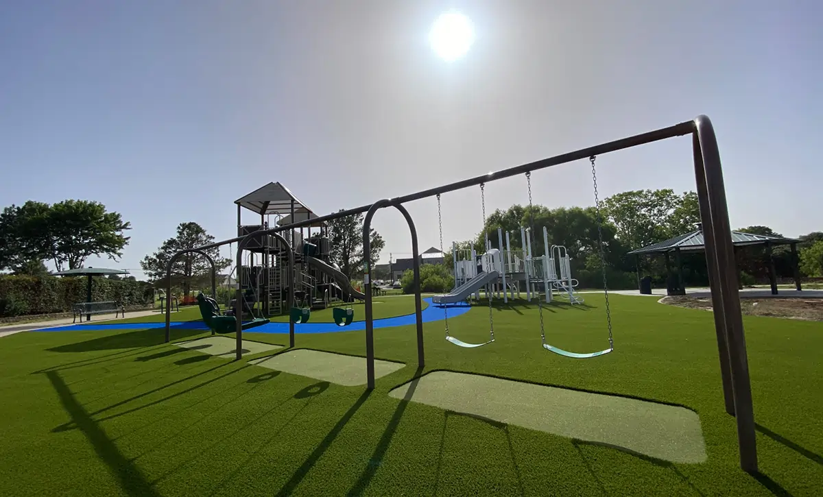 flower-mound-artificial-grass-swingset Artificial playground grass swingset installed by SYNLawn